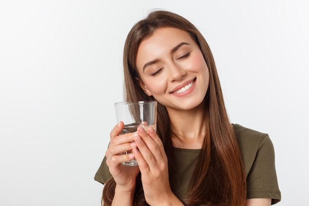 portrait of attractive caucasian smiling woman drinking water.