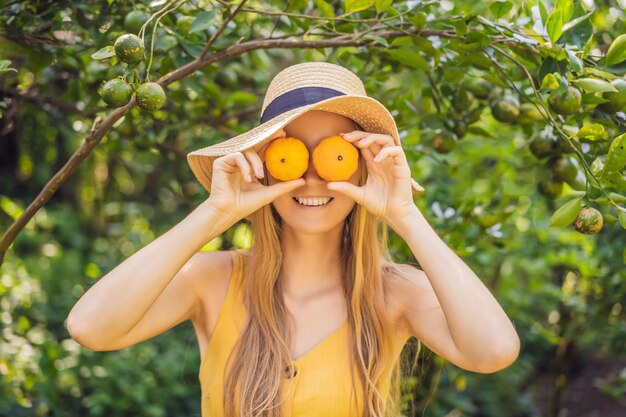 Portrait of Attractive Farmer Woman is Harvesting Orange in Organic Farm Cheerful Girl in Happiness Emotion While Reaping Oranges in The Garden Agriculture and Plantation Concept