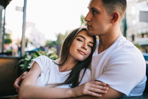 Portrait of attractive female looking at camera while spending free day with lovely boyfriend care