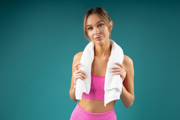 portrait of an attractive female in sportswear with a towel