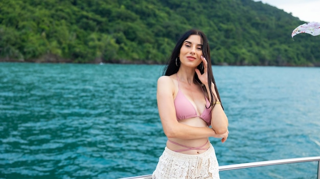 Portrait Attractive Happy beautiful sexy Asian female wearing swimwear enjoying on boat deck sailing luxury yacht Vacation trip summer holiday