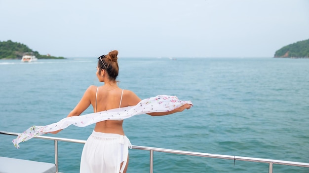 Portrait Attractive Happy beautiful sexy Asian female wearing swimwear enjoying on boat deck sailing luxury yacht Vacation trip summer holiday