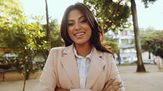 Portrait of an attractive Latin woman walking in the park at fall on a sunny day and smiling The face of a happy beautiful woman outdoor