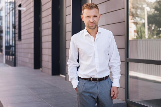 Portrait of an attractive man in a shirt near the office