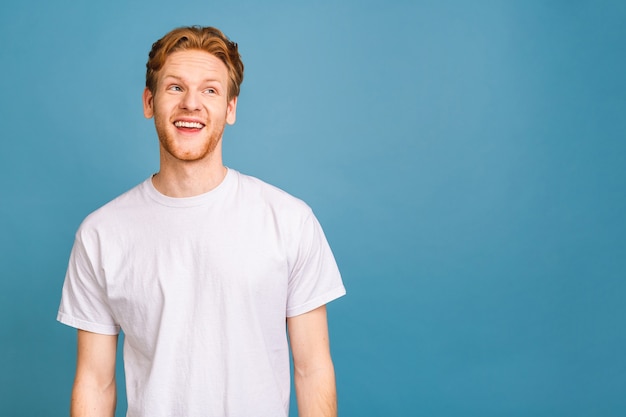 portrait of attractive red-haired caucasian young man wearing casual