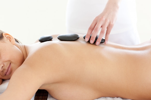 Portrait of an attractive woman having a massage with stones