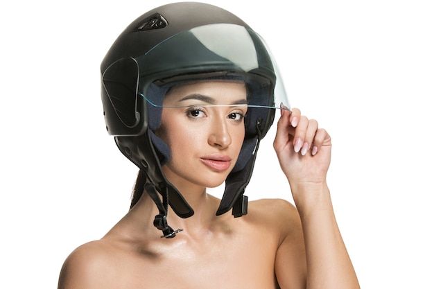 Portrait of attractive woman in motorbike helmet on white studio background. Beauty, skin and facial protection concept