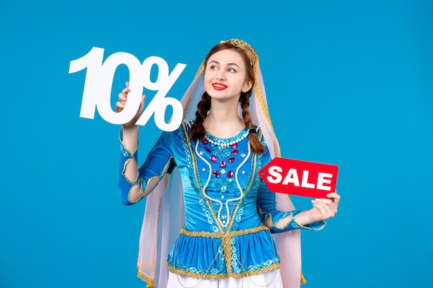 portrait of azeri woman in traditional dress holding sale text and percent discount