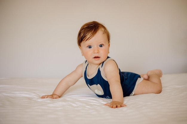 portrait of a baby in bed on a white background