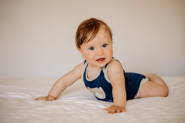 portrait of a baby in bed on a white background