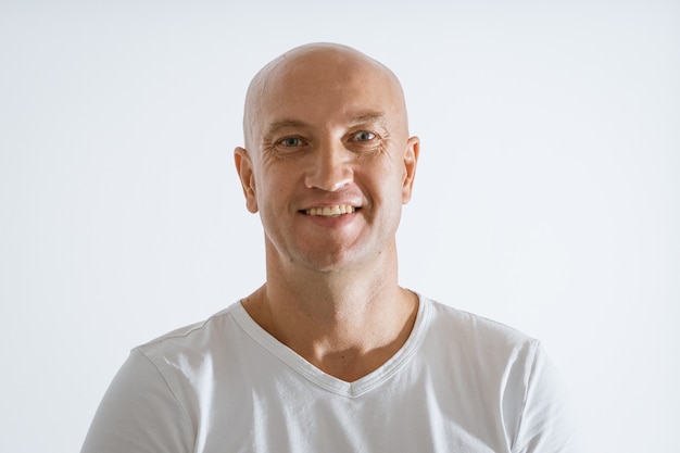 Portrait of a bald emotional man in a white t-shirt