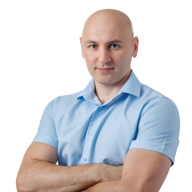 Portrait of a bald guy in a blue shirt on a white background The confident man has his arms crossed over his chest