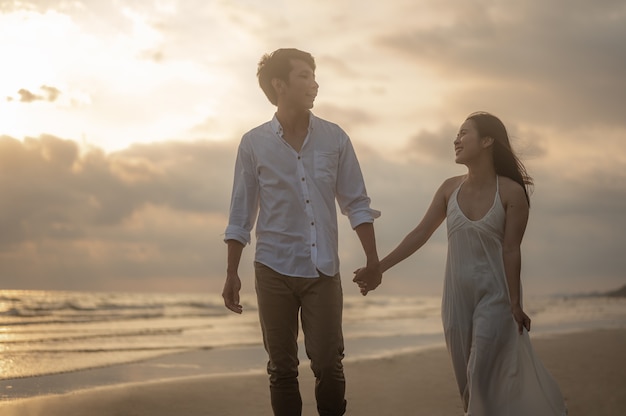 Portrait beach vacation romantic walk couple relaxing on ocean summer travel destinationY