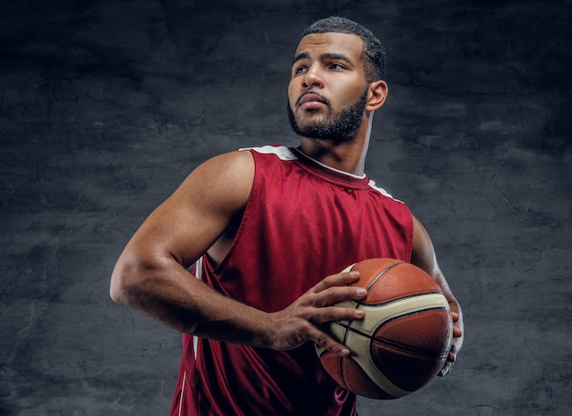 Portrait of a bearded black man holds a basket ball.