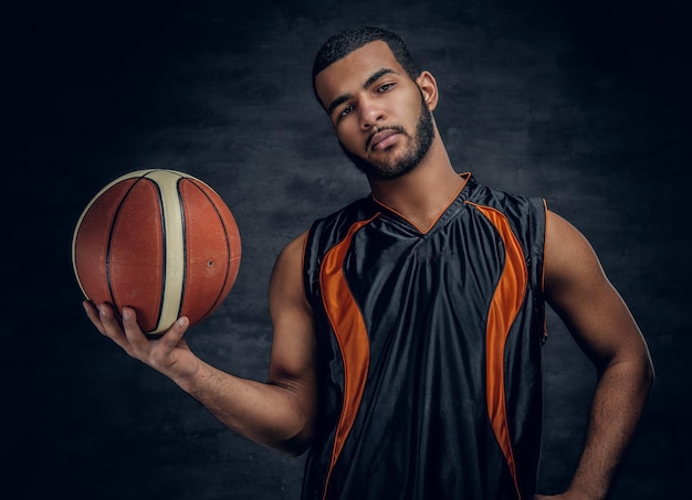 Portrait of a bearded black man holds a basket ball.