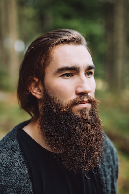 Portrait of a bearded boy in the woods