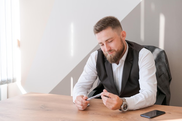 Portrait bearded business man sitting in office meditating holding pen in his