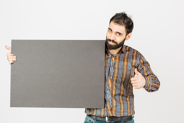 Photo portrait of a bearded businessman holding a black blank panel with space for text isolated on white background