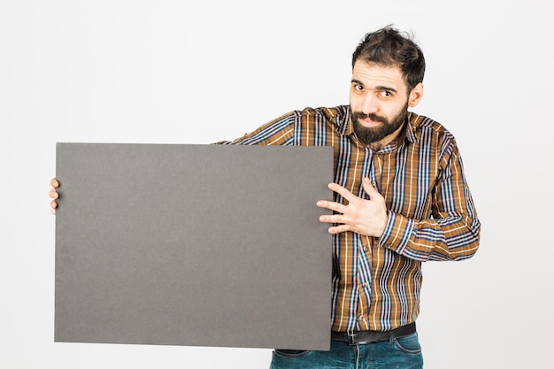 Photo portrait of a bearded businessman holding a black blank panel with space for text isolated on white background