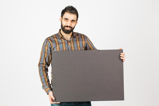 Photo portrait of a bearded businessman holding a black blank panel with space for text isolated on white background