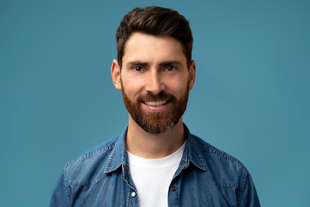 Portrait of bearded handsome man in casual style looking at the camera and smiling