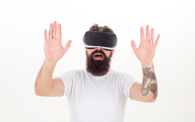 Portrait of bearded male in a white Tshirt with virtual reality glasses on his head isolated white