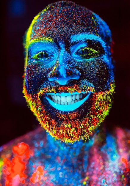 Portrait of a bearded man painted in fluorescent powder.