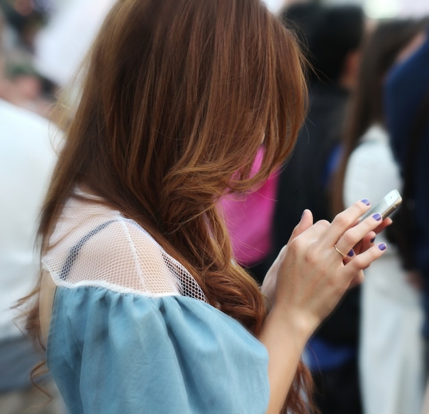 portrait of bearded woman long hair dressed in stylish clothes chatting on cell telephone 