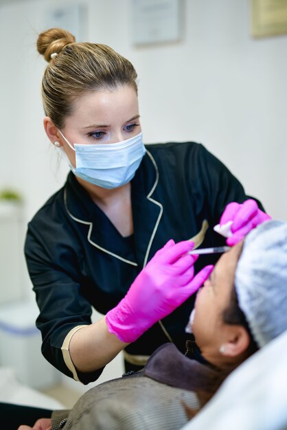 Portrait of beautician doctor with syringe in hand