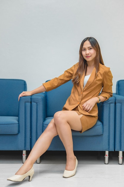 Portrait of beautiful asian business woman wear yellow dress in a officeThailand people wear ladies uniforms officeSexy woman on sofa