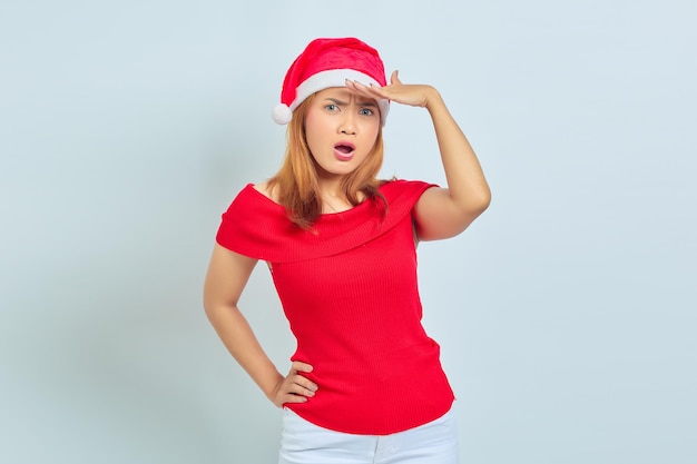 Portrait of beautiful Asian girl in christmas hat with surprise fasial expression and open mouth