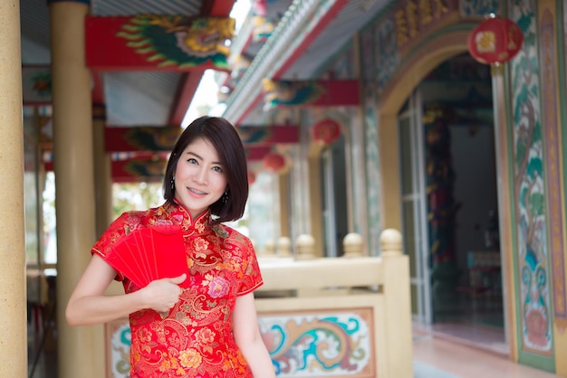 Portrait of beautiful asian woman in Cheongsam dressThailand peopleHappy Chinese new year concept