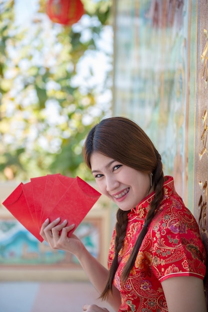 Portrait of beautiful asian woman in Cheongsam dressThailand peopleHappy Chinese new year concept