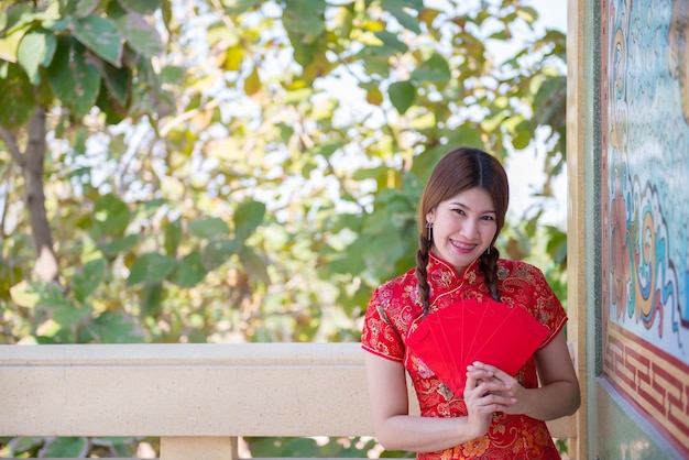 Portrait of beautiful asian woman in Cheongsam dressThailand peopleHappy Chinese new year concept