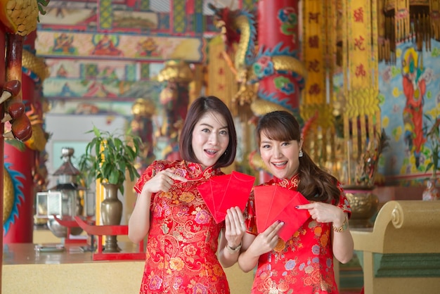 Portrait of beautiful asian woman in Cheongsam dressThailand peopleHappy Chinese new year concept