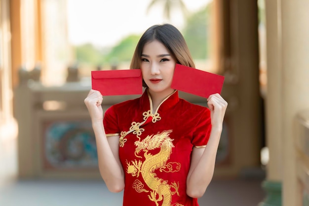 Portrait beautiful asian woman in Cheongsam dressThailand peopleHappy Chinese new year conceptHappy asian lady in chinese traditional dress