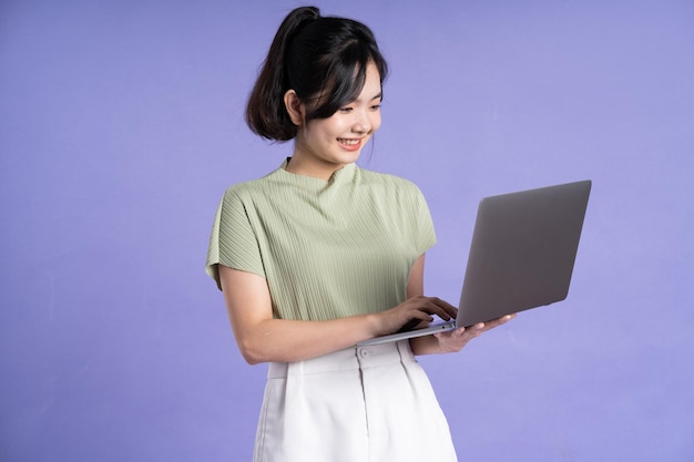 Portrait of beautiful asian woman posing on purple background