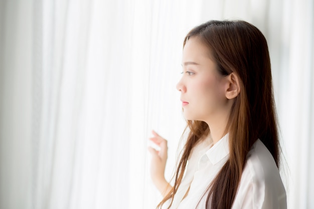 Portrait beautiful asian woman standing the window