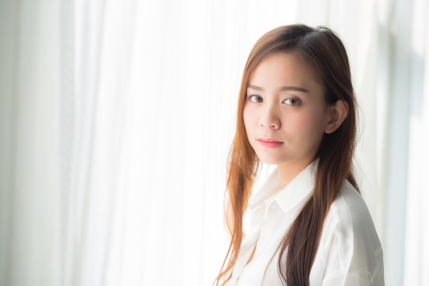 Portrait of beautiful asian woman standing the window