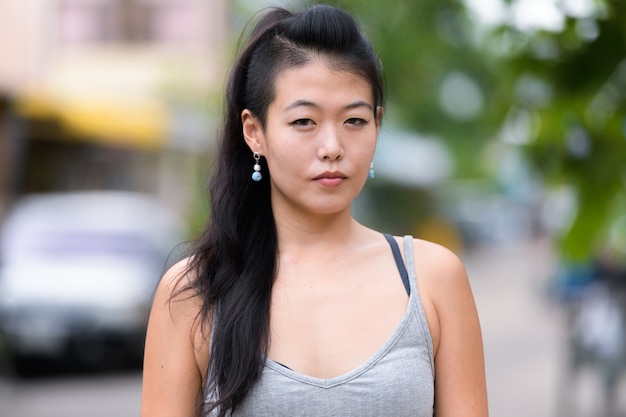 Portrait of beautiful Asian woman in the streets outdoors