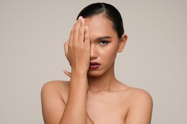 Portrait of beautiful asian woman use hand cover her eye,