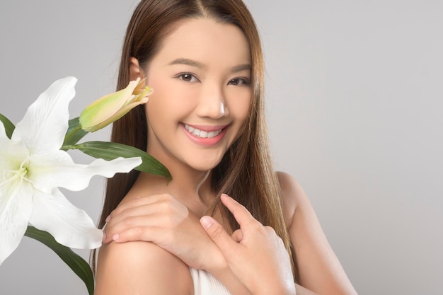 Portrait of beautiful asian woman over white background studio skin care and beauty concept