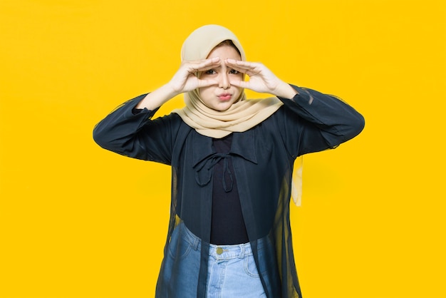 Portrait of beautiful Asian woman on yellow wall