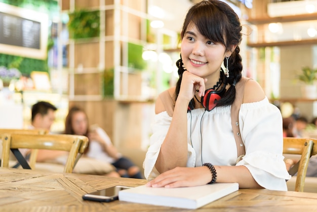 Portrait of beautiful Asian young woman smiling and happiness with headphone 