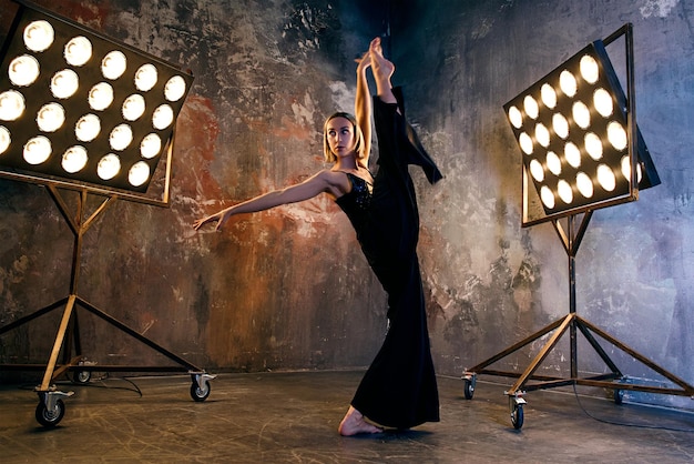 portrait of beautiful attractive blonde woman contemporary dancer jumping high in the loft