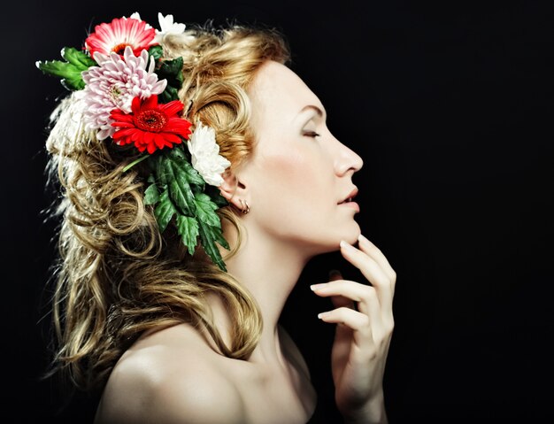 Photo portrait of beautiful blond girl with flowers in her hair