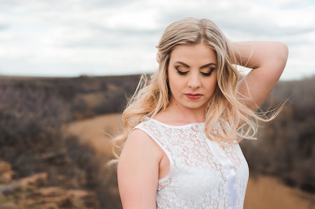 Portrait of beautiful blond woman in a field.