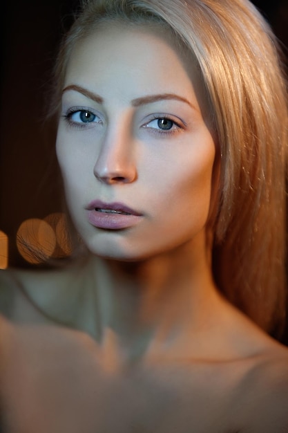 Portrait of a beautiful blonde on a dark background