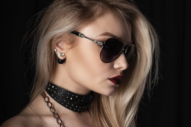 Portrait of a beautiful blonde woman with dark glasses looking away