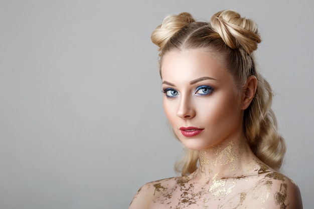 Portrait of beautiful blonde woman with makeup beauty photoshoot on background.